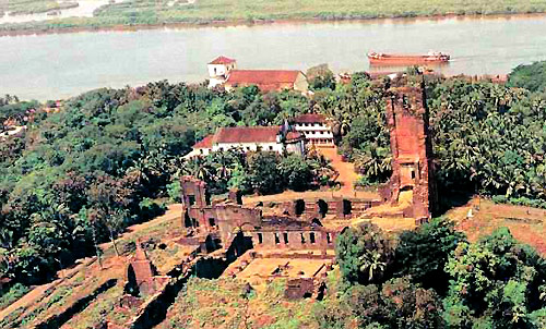 Goa's Church of Our Lady of Grace, and the Augustinian monastery in the foreground. They share a flat hilltop, the Monte Santo (Holy Hill).