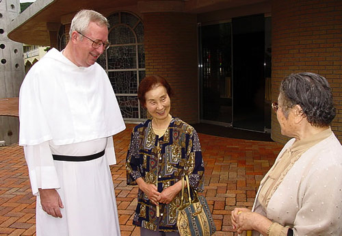 An Augustinian chats in front of the Augustinian church, Nagasaki.