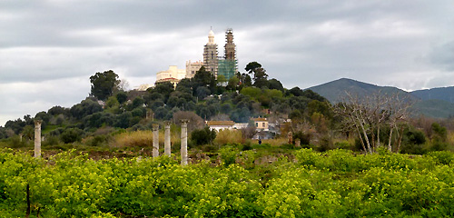 The green foreground is Hippo. The church on the hill in the distance is the present Minor Basilica of St Augustine, Annaba, Algeria. 
